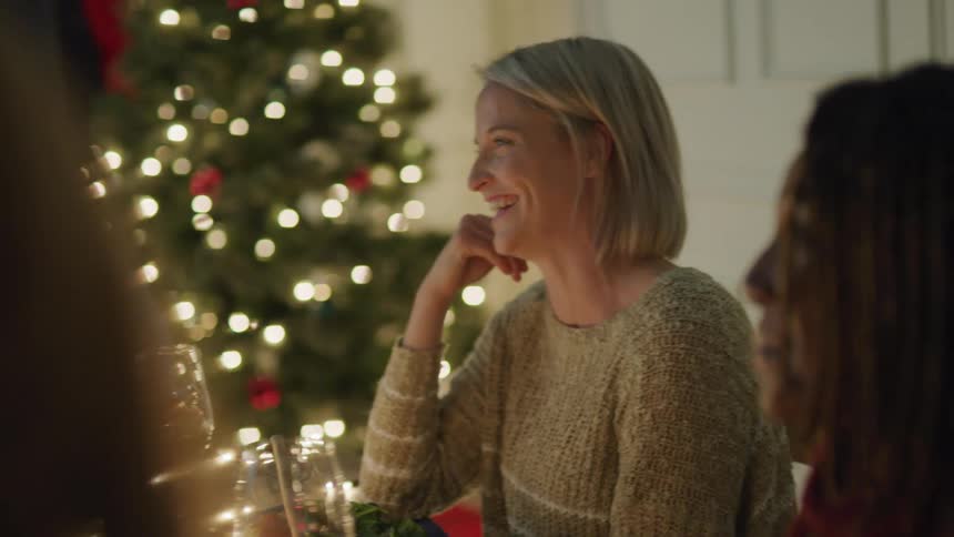 People happily chatting while sitting at a dinner table