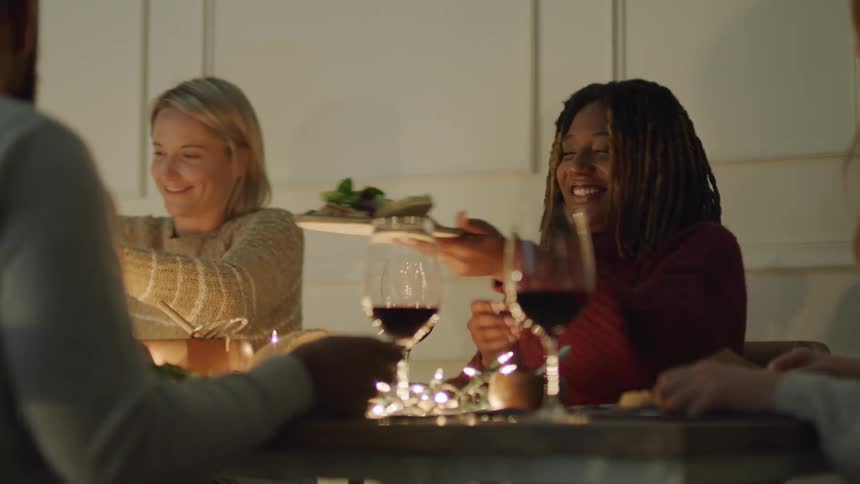 People sitting at a table serving themselves