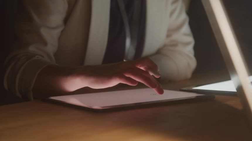 Person interacting with a tablet on a table