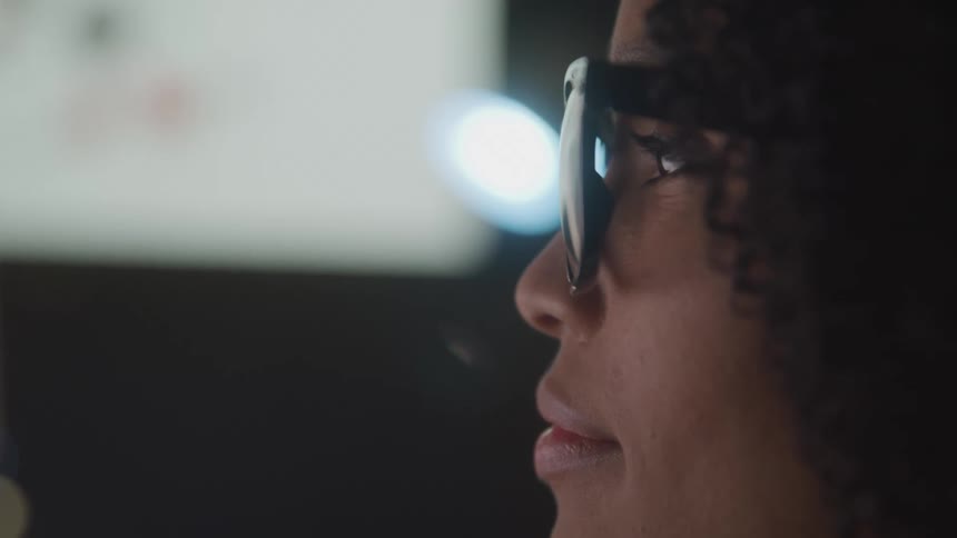 A woman is reading a monitor