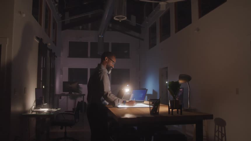 A man is working in the office at night