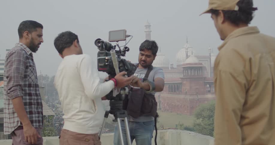 A crew member is setting up the camera