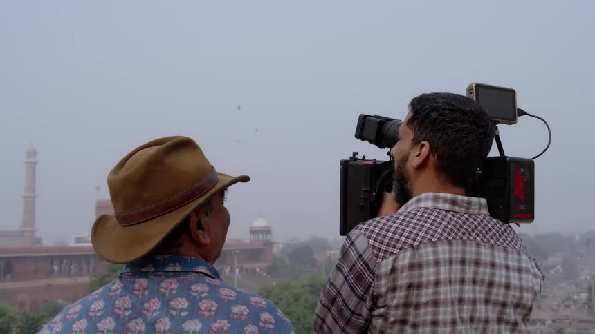 Filmmakers are capturing a cityscape with a camera