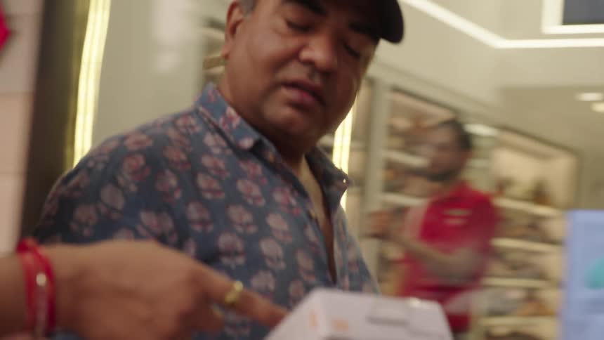 People walk through the mall talking