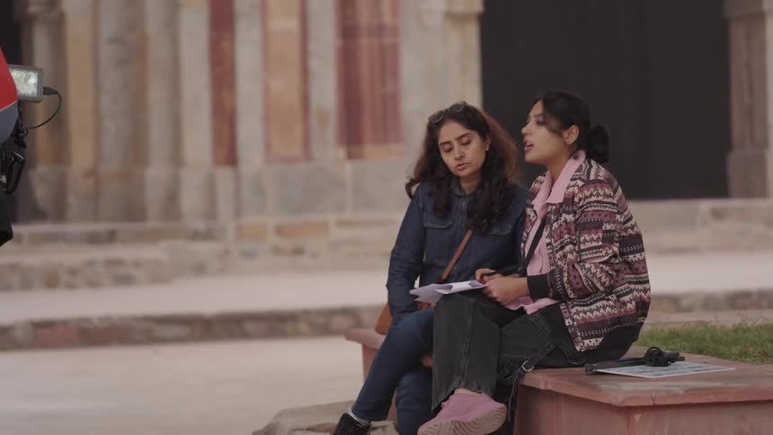 A man sits down with two women and talks