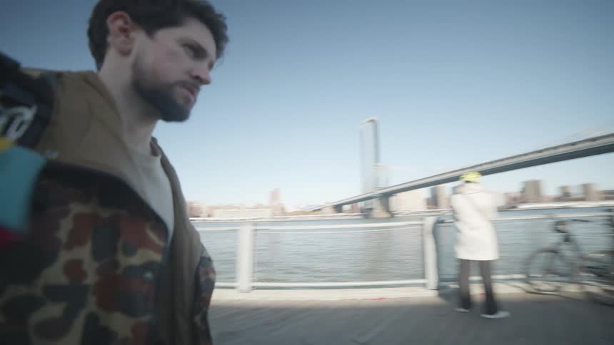 A tourists carries his luggage on the boardwalk