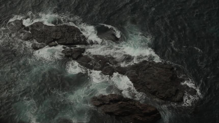 Ocean waves crash into rocks