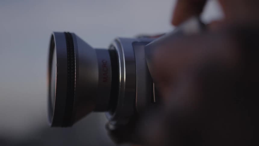 Man is taking pictures with his camera of the outdoors landscape