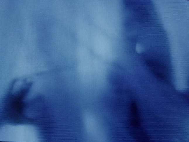 Shadow of an abstract human body moving behind a sheet in a lowlight environment