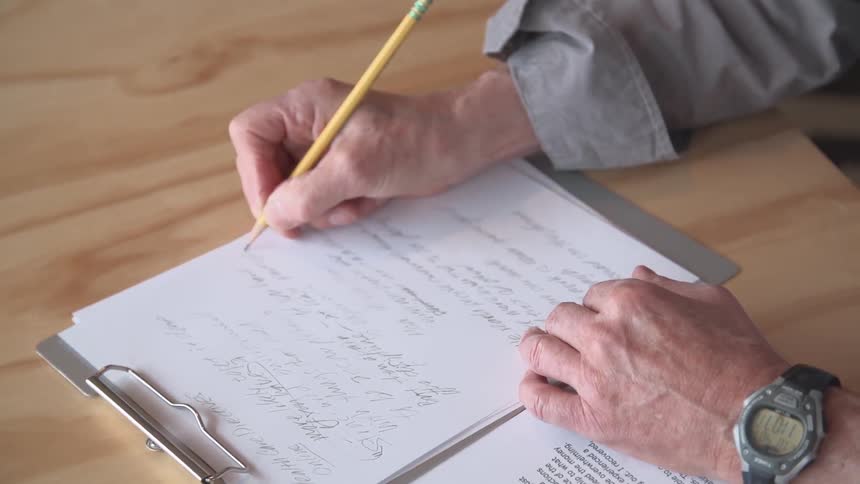 A person writing on paper