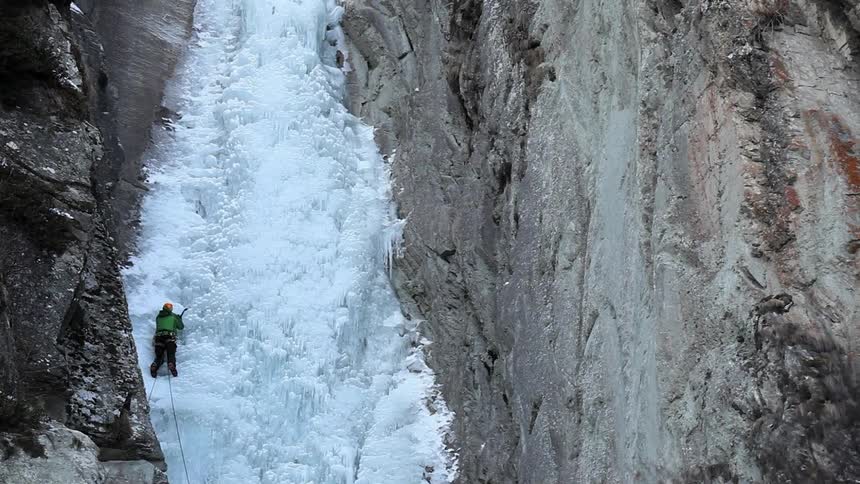 Rock climber negotiating an icy wall
