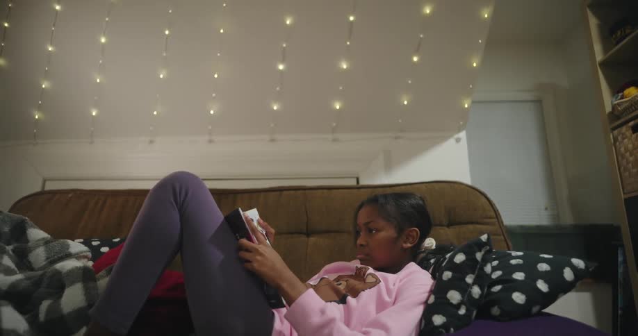 A girl reading on a couch