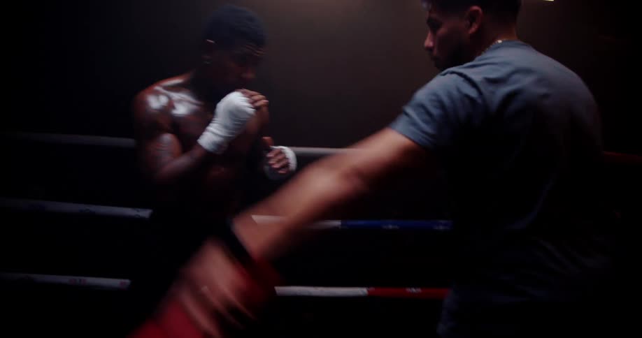 A boxer is dodging in the ring