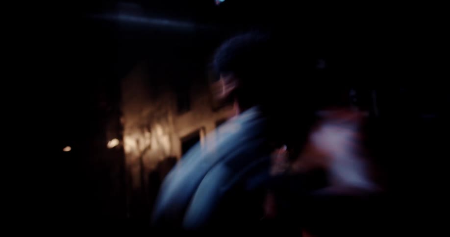 Man in a lowlight environment throwing boxing punches