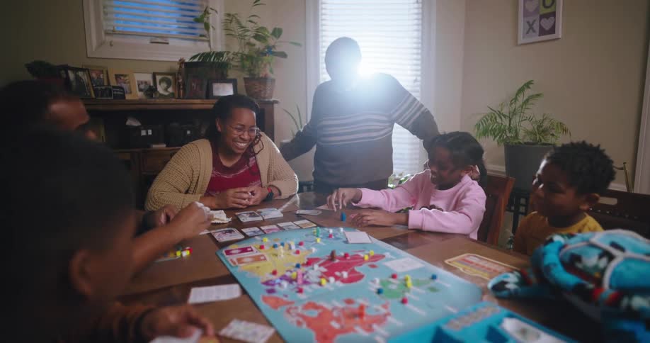 A family are playing a board game at home