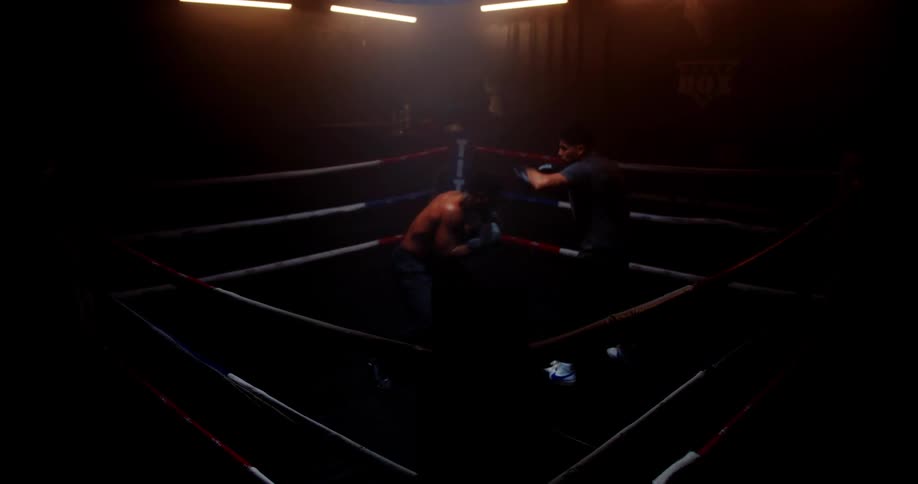 Two men are sparring in the ring