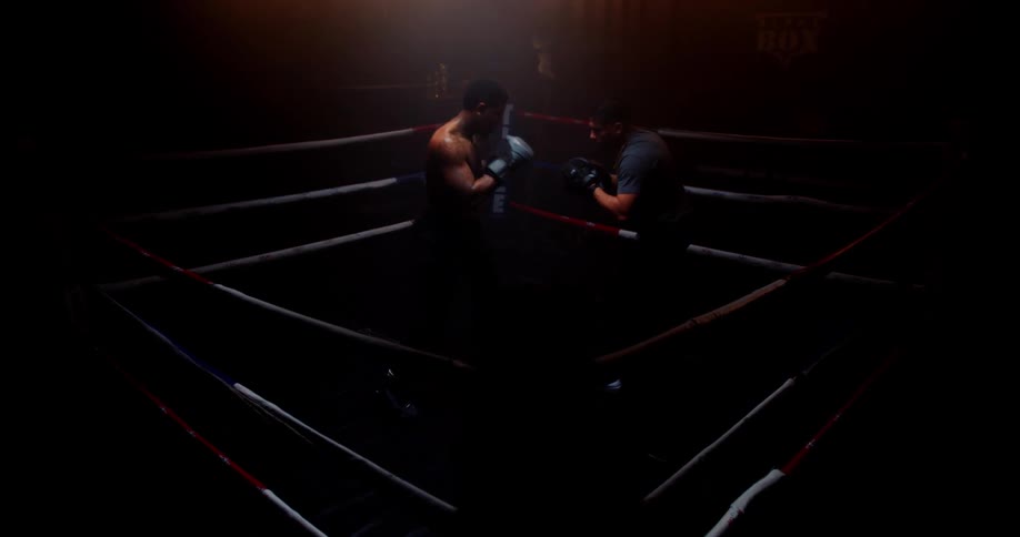 Two men are boxing in a ring