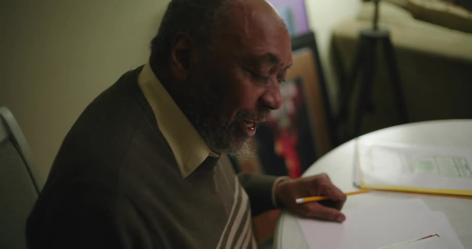 A man helping a boy with homework