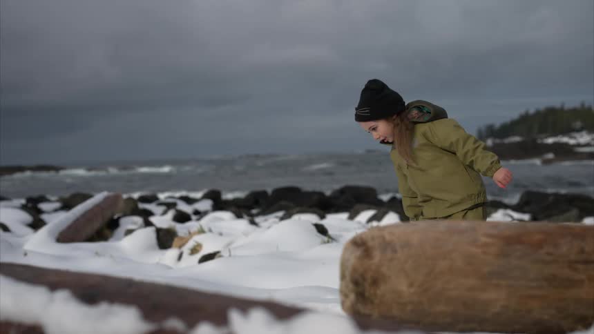 A footage of a female child playing in the snow