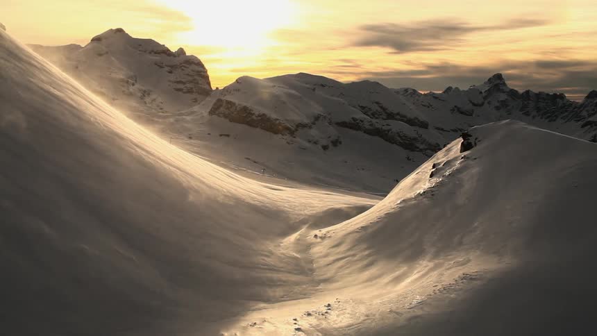 Winds blowing snow down a mountain side