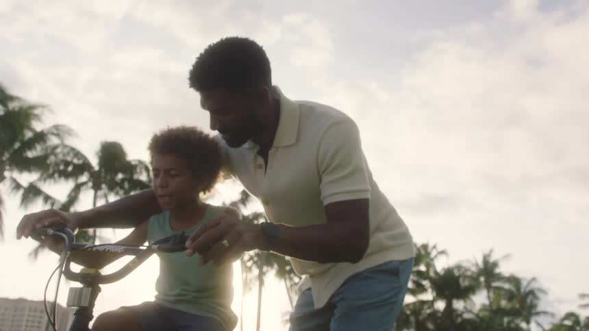 Father teaching his son to ride a bike