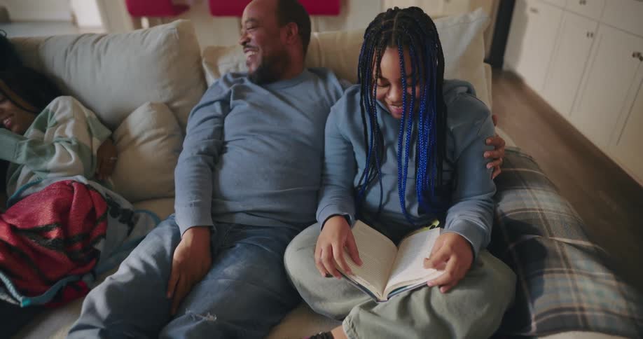 Family hanging out on the couch laughing and relaxing