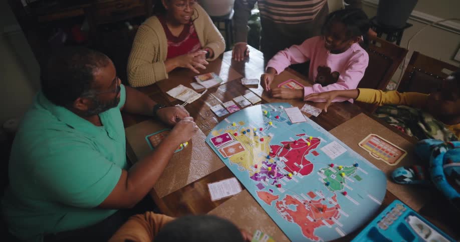 A family are having fun playing a board game