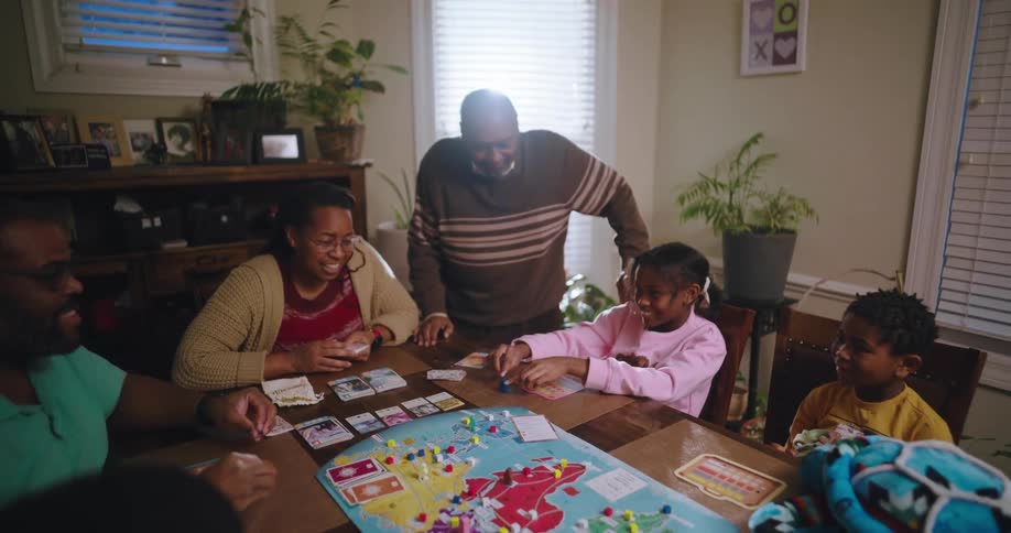 A family is having fun while playing a board game together