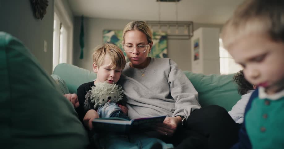 A mother is reading to her son