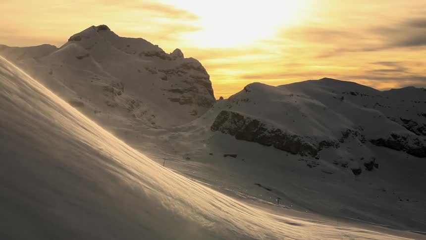 Winds blowing snow down a mountain side