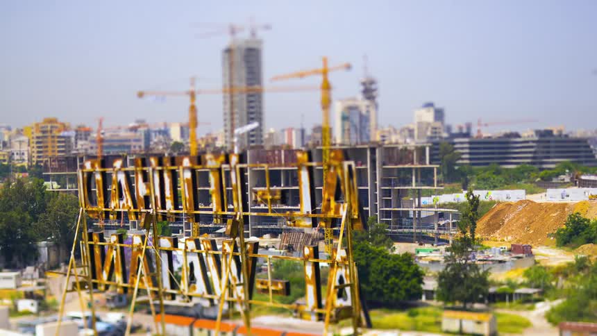 Construction cranes spin in the city