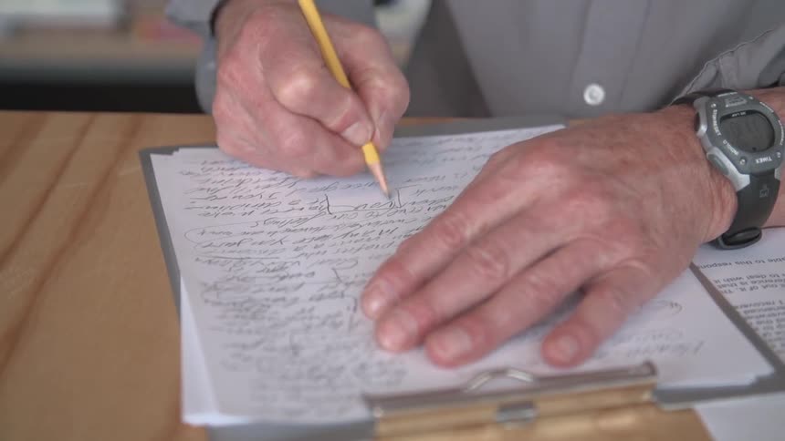 A person writing on paper