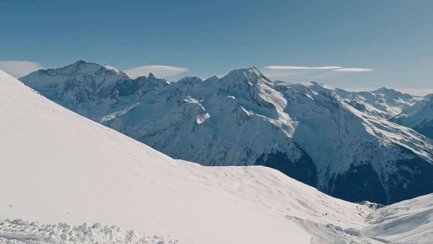 Snow covered mountains stand tall in the winter landscape