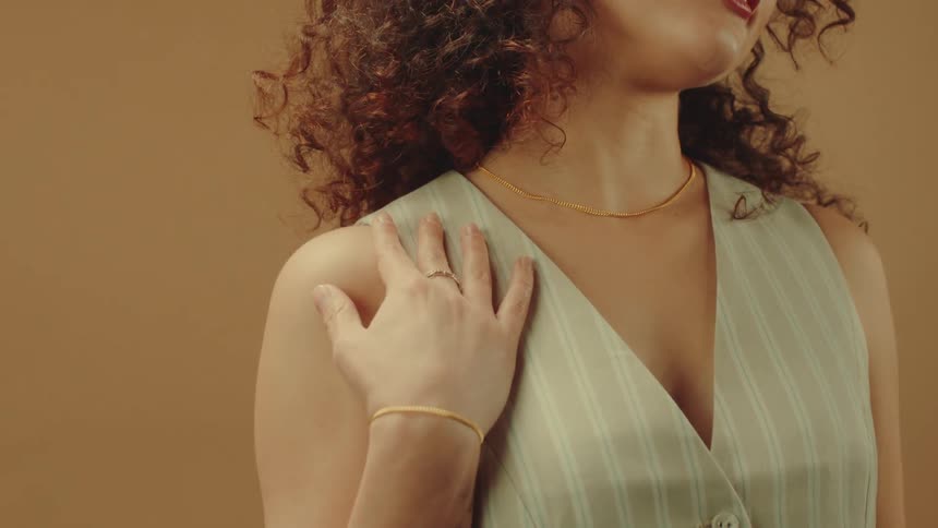 A woman is modeling a gold bracelet