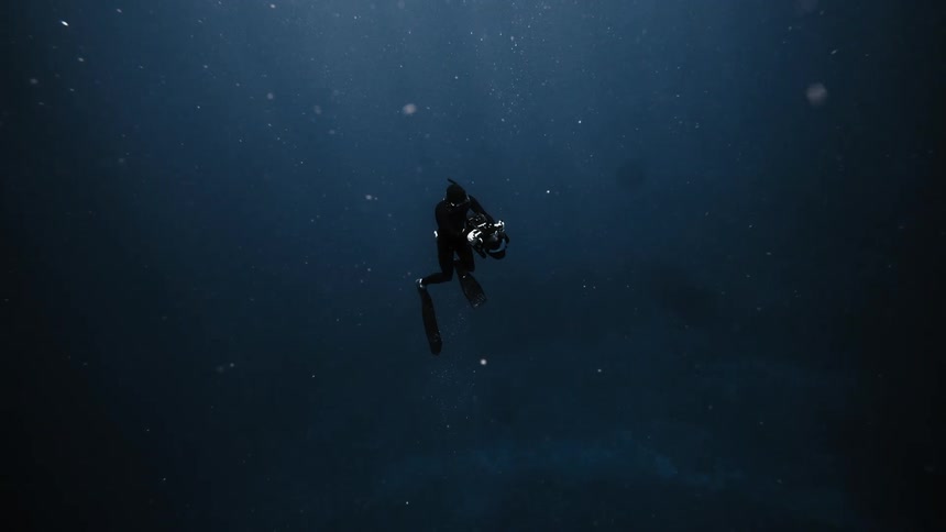 A diver is taking photographs underwater