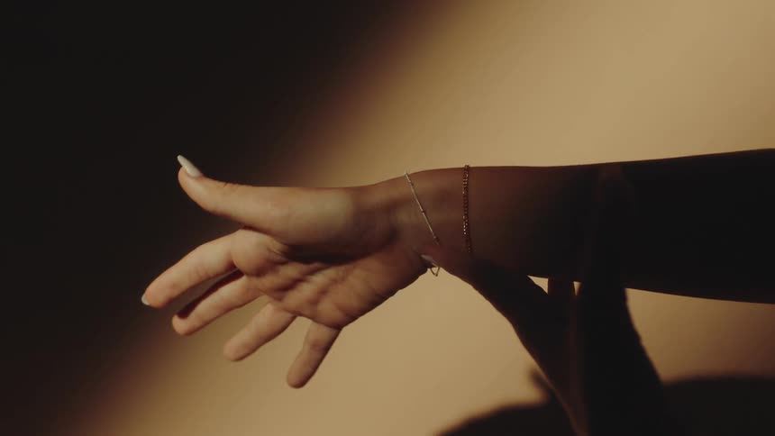 Female arm extended with two shiny bracelets