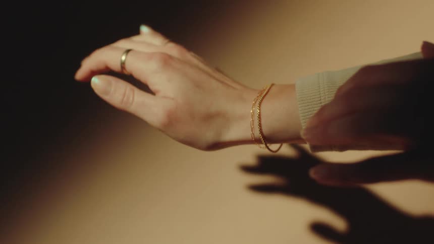A person shows off their jewelry