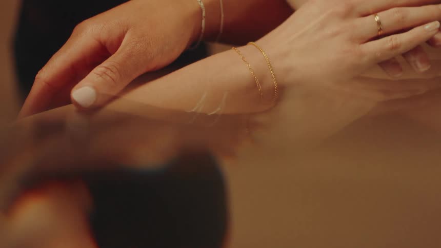 Two hands are modeling jewelry
