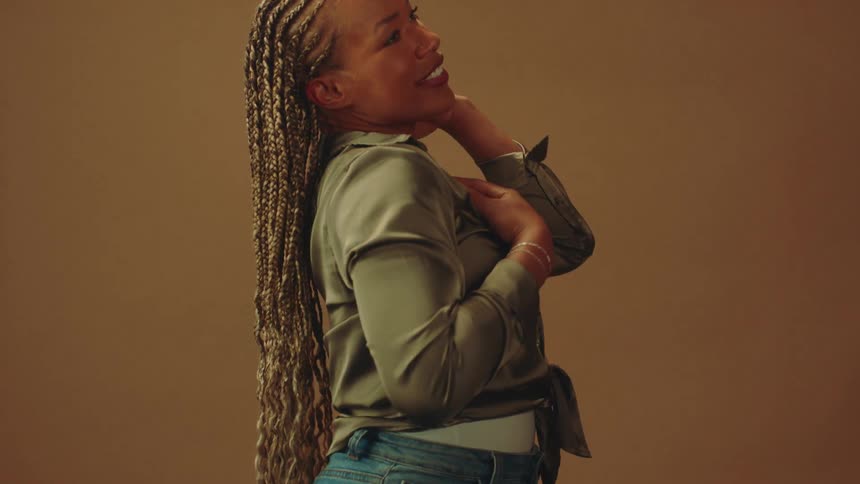 Female model with braided hair posing in a studio