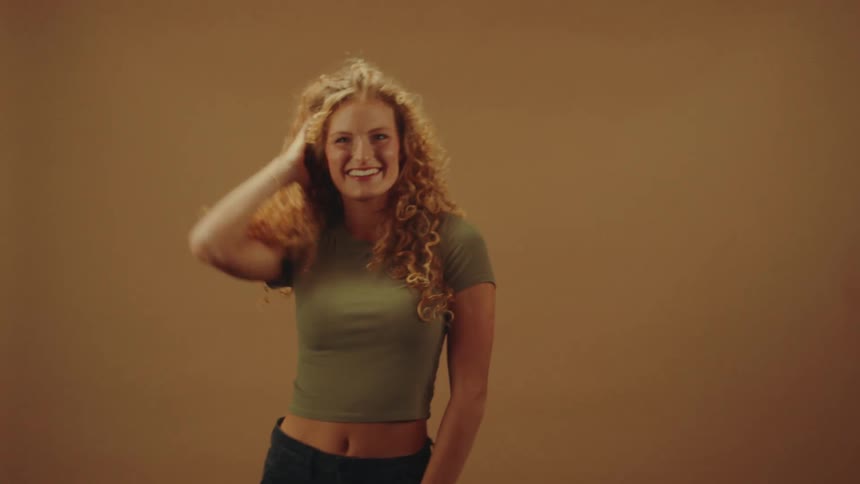 A footage of a lady model posing and smiling for the camera