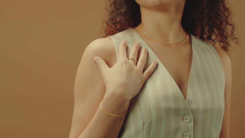 Woman posing wearing gold ring and bracelet