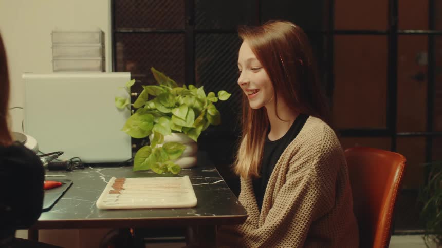 Young woman sitting on a chair smiling