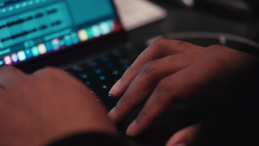 Person is typing on their laptop while sitting indoors