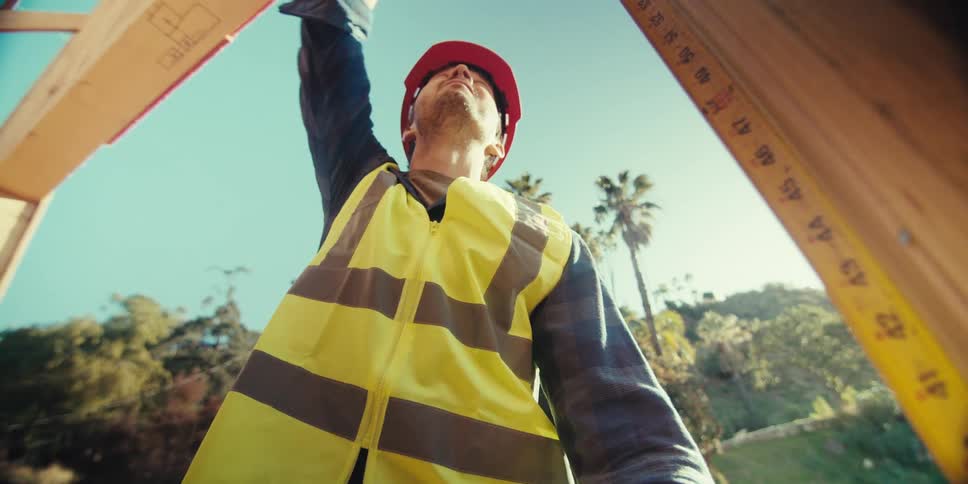 A construction worker is measuring a doorway