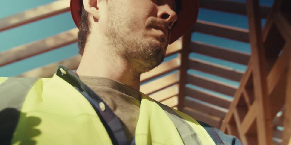 A construction worker uses a red string to measure a doorframe