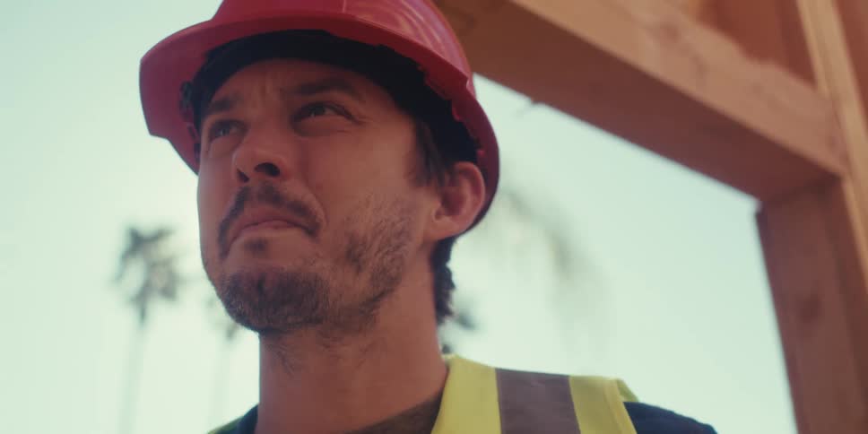 A footage of a carpenter nailing a wooden construction