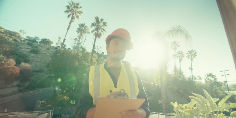 A construction worker is taking notes on site
