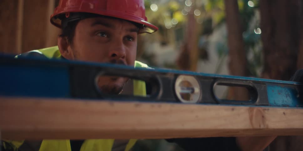 A clip of a carpenter ruling a wood