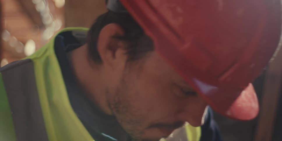 A construction worker looks up while working