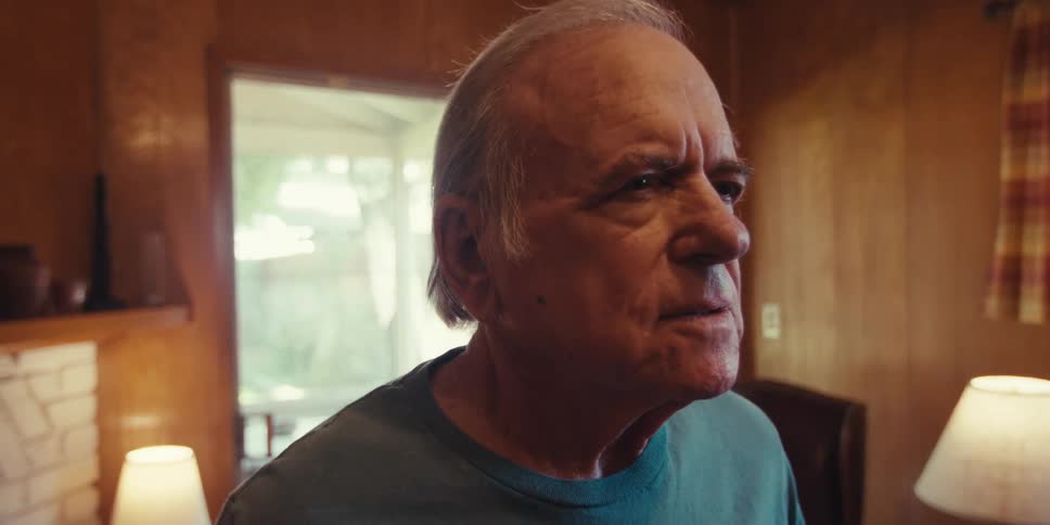 Elderly man doing breathing excersises in living room